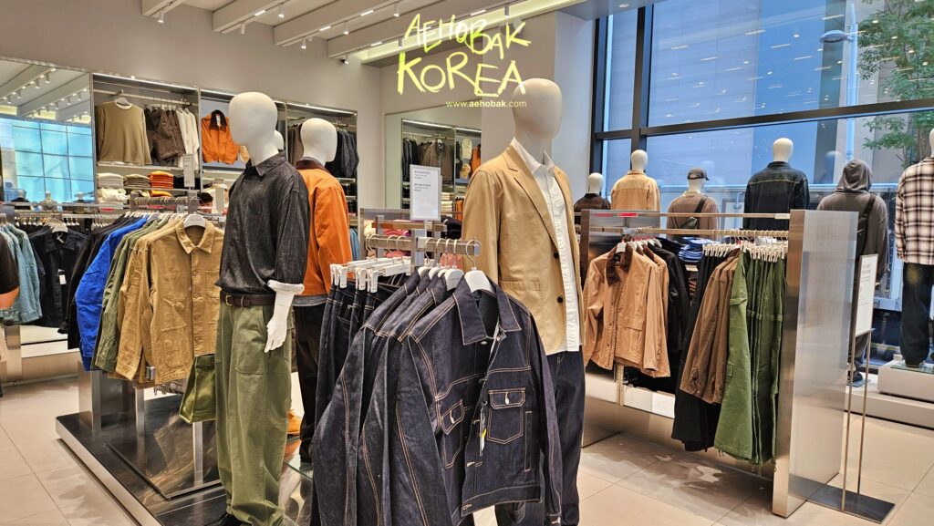 Clothing racks with jeans, jackets, and T-shirts at Musinsa Standard Myeongdong.