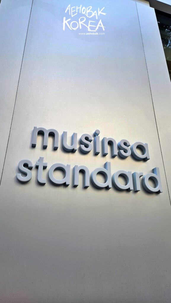 Musinsa Standard logo sign on the exterior wall in Myeongdong.