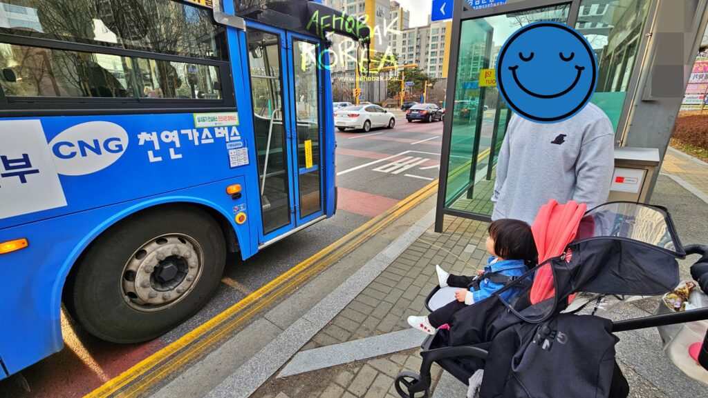 Waiting for the real ‘Tayo bus’ in Seoul – a magical moment for toddlers who love the blue city buses.